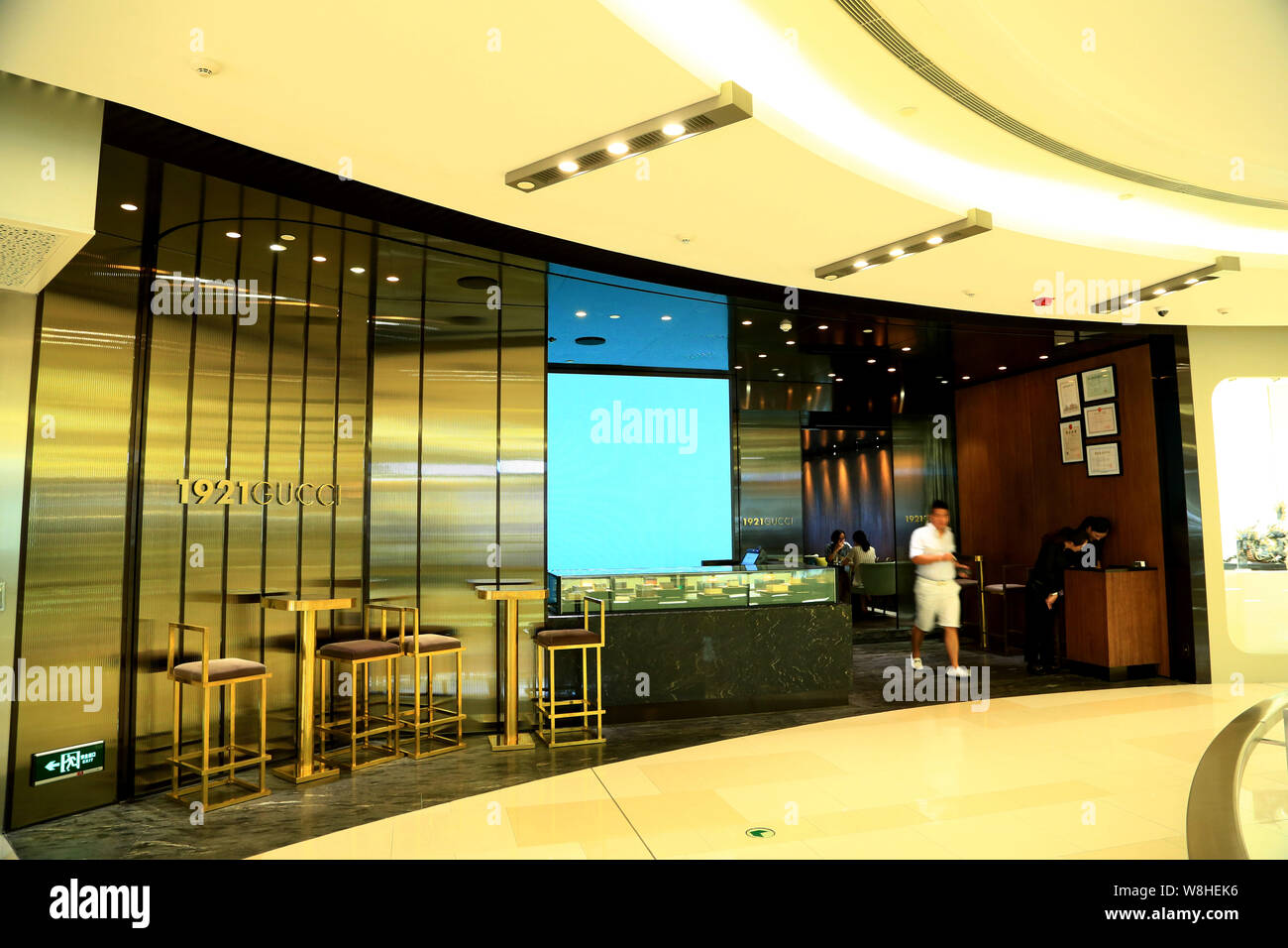 A customer leaves the 1921 Gucci restaurant at the IAPM shopping mall in  Shanghai, China, 17 August 2015. The 1921 Gucci restaurant opened in Shangh  Stock Photo - Alamy