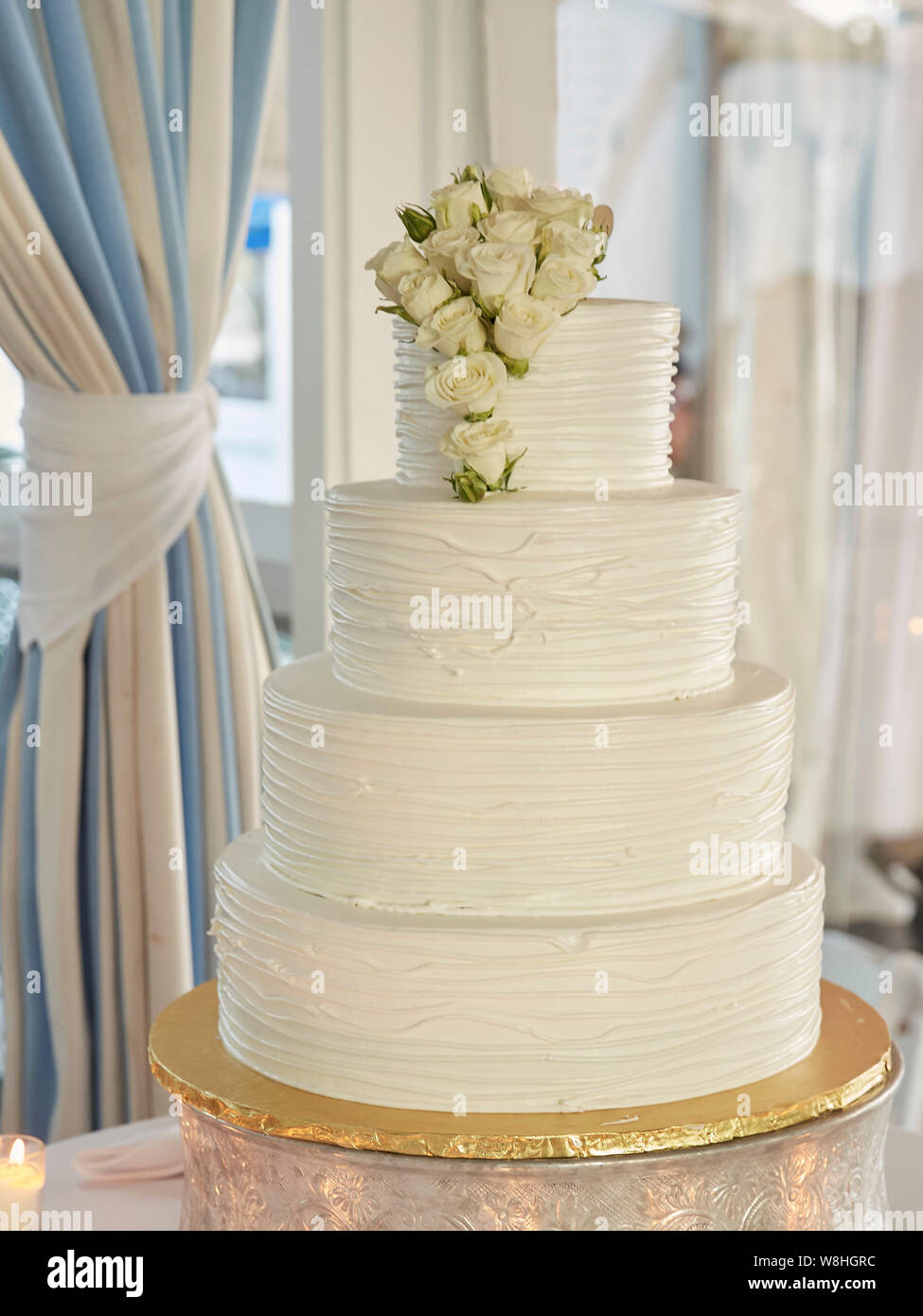 Multi-Tiered Wedding Cake with White Roses Stock Photo