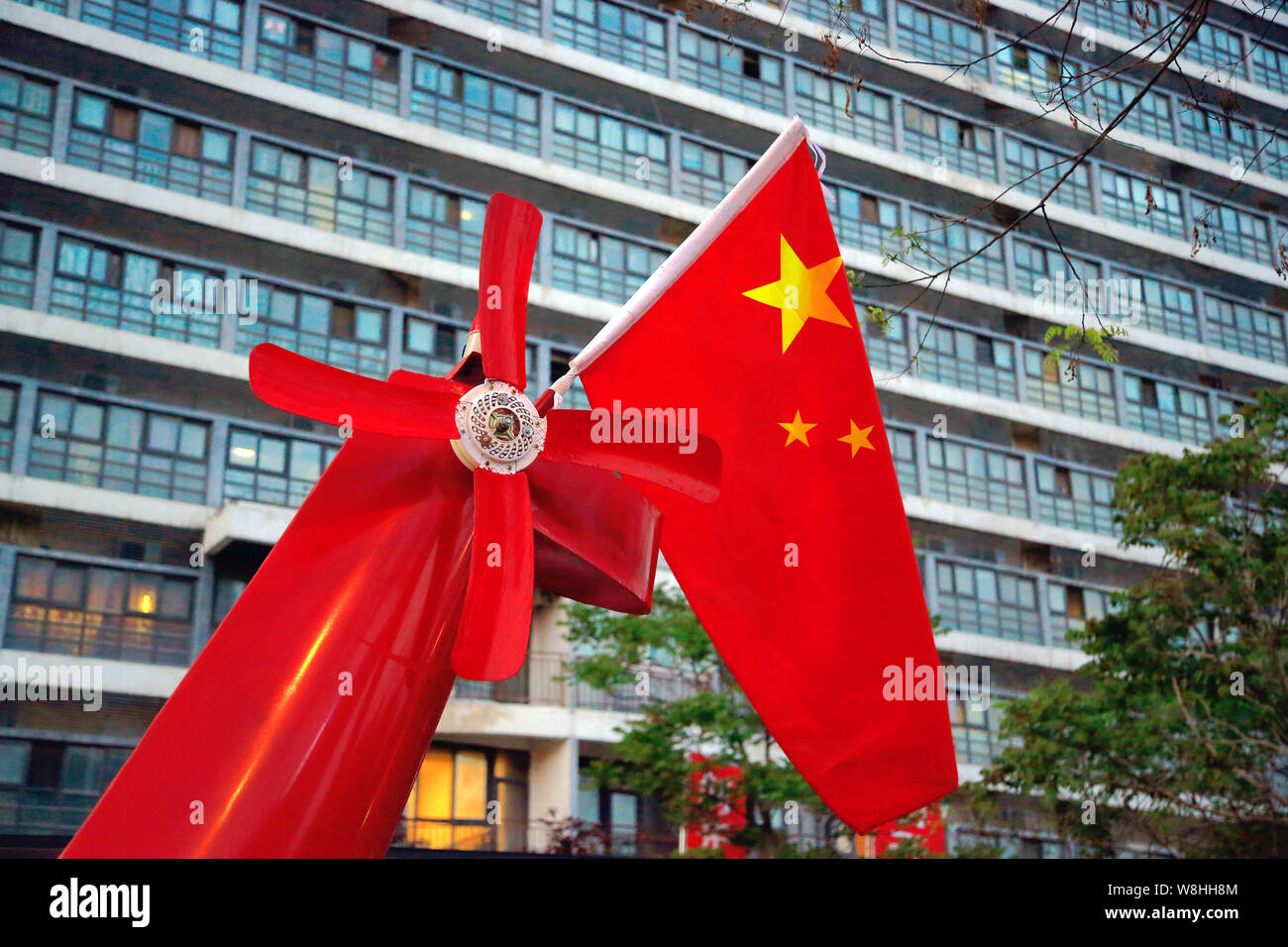 A Chinese national flag is installed on the empennage of the homemade helicopter-shaped vehicle built by retired Chinese engineer Yuan Jingying on a r Stock Photo