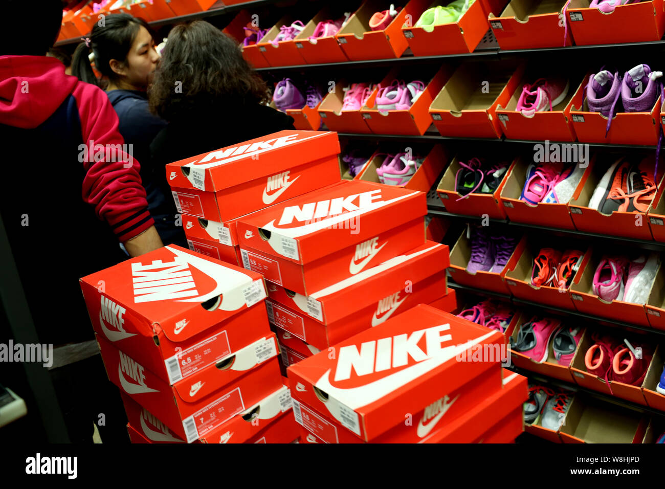 FILE--Customers shop for Nike sports shoes at a Nike sportswear store in  Shanghai, China, 21 February 2015. Foreign direct investment (FDI) to the  Stock Photo - Alamy