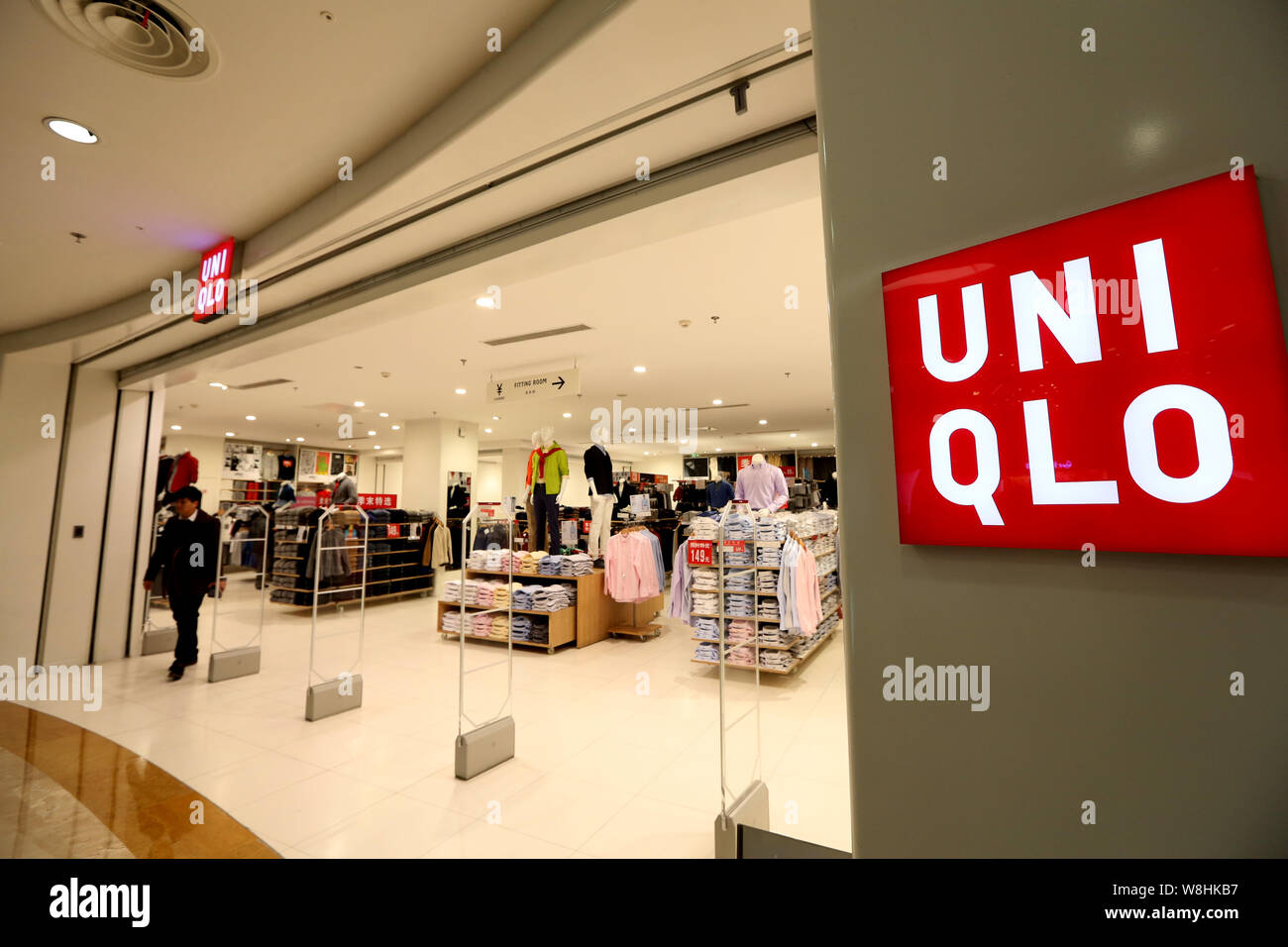 FILE--A customer leaves a store of Uniqlo at a shopping mall in Shanghai,  China, 16 January 2015. The parent company of Japanese fast-fashion reta  Stock Photo - Alamy