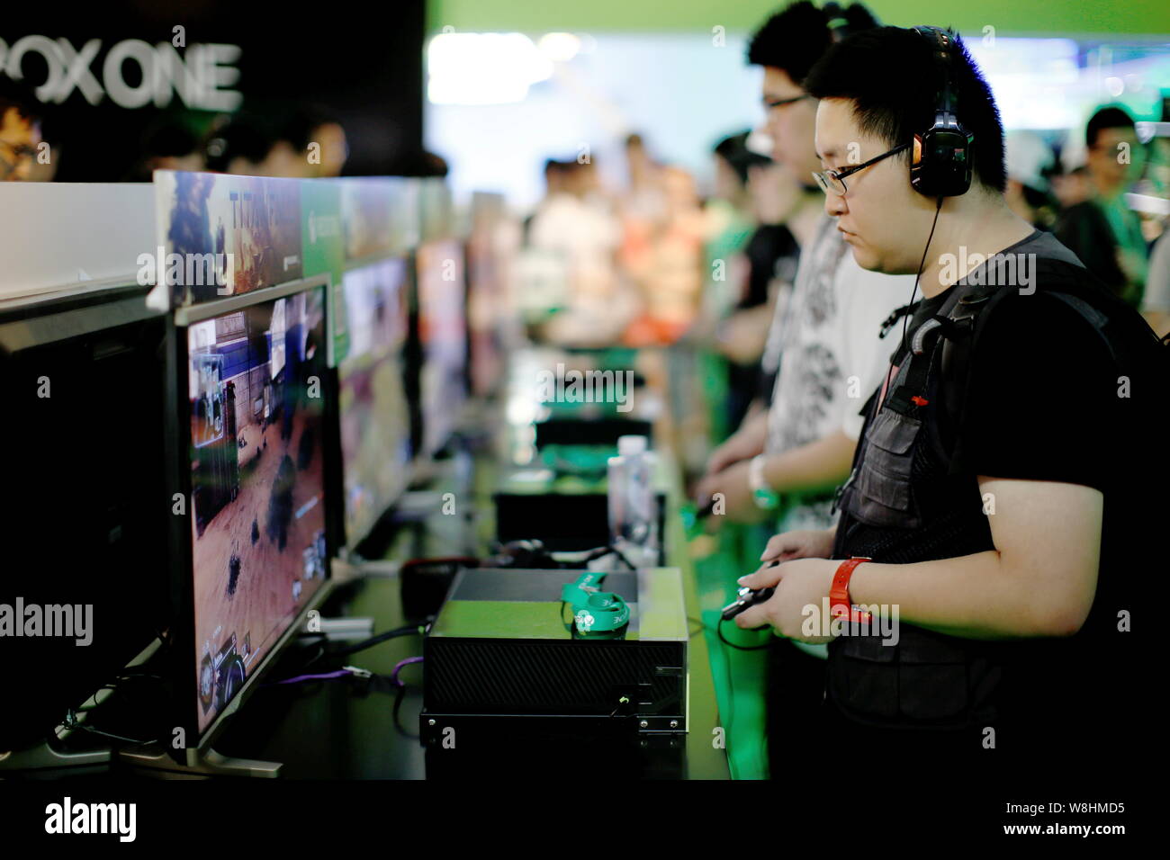 FILE--A young boy plays electronic games on an XBOX ONE game console at a  physical store of Microsoft in Shanghai, China, 26 December 2014. Produc  Stock Photo - Alamy