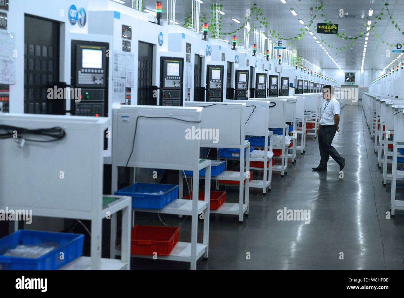 Worker walks past line hi-res stock photography and images - Alamy