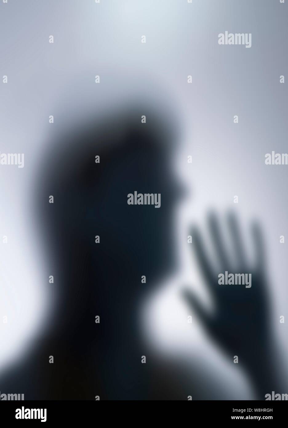 Silhouette of person's head and hand. Stock Photo