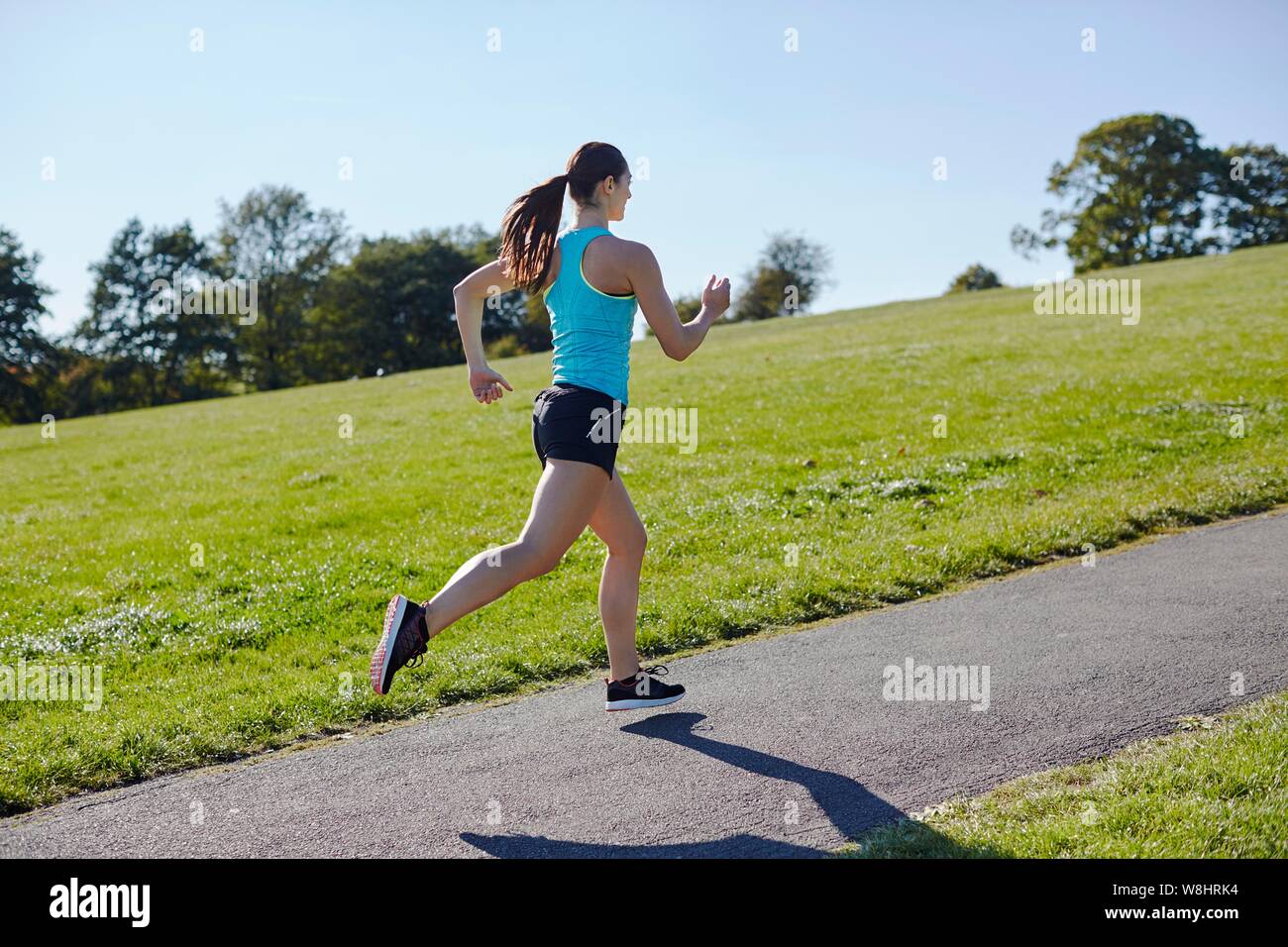 Young woman jogging on a path. Stock Photo