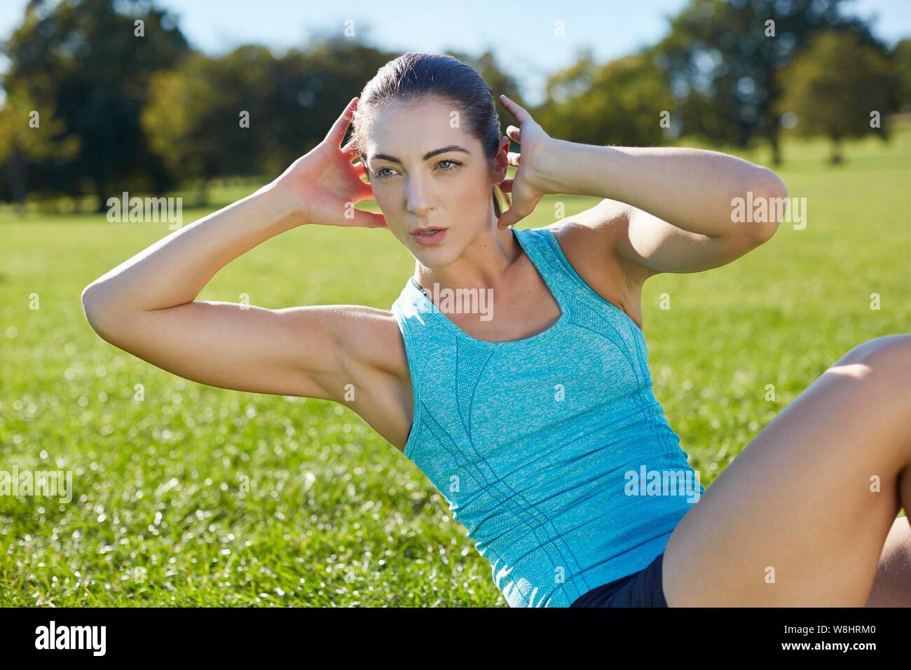 Young woman doing crunch. Stock Photo