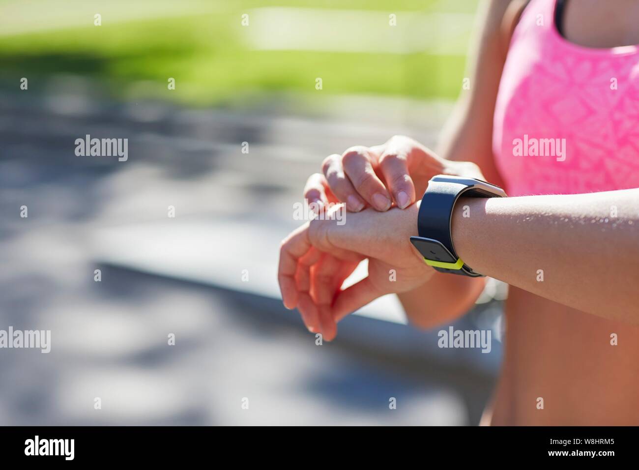 Woman wearing sports watch checking the time. Stock Photo