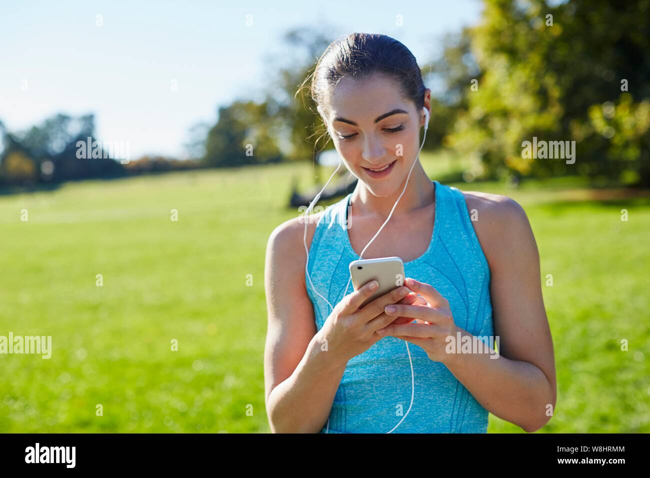 Young woman listening to music from smart phone. Stock Photo