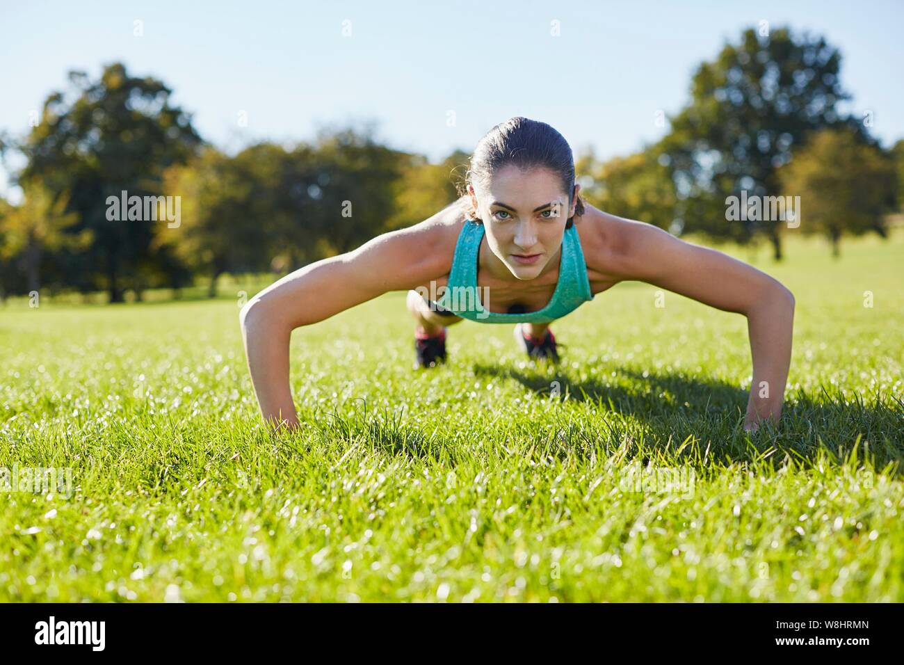 Young woman doing push-up. Stock Photo