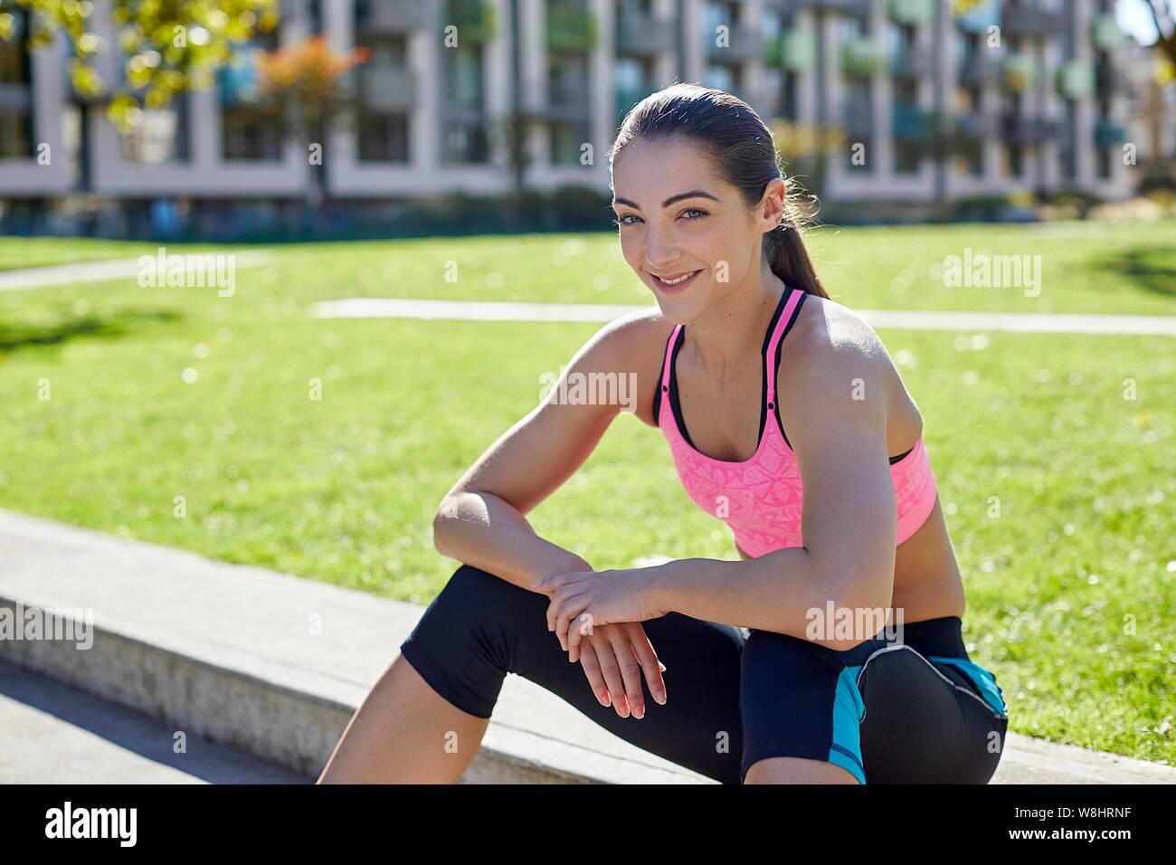 Young woman sitting on steps, resting. Stock Photo