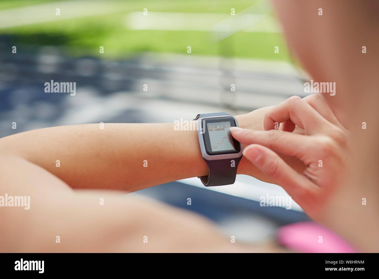 Woman wearing sports watch checking the time. Stock Photo
