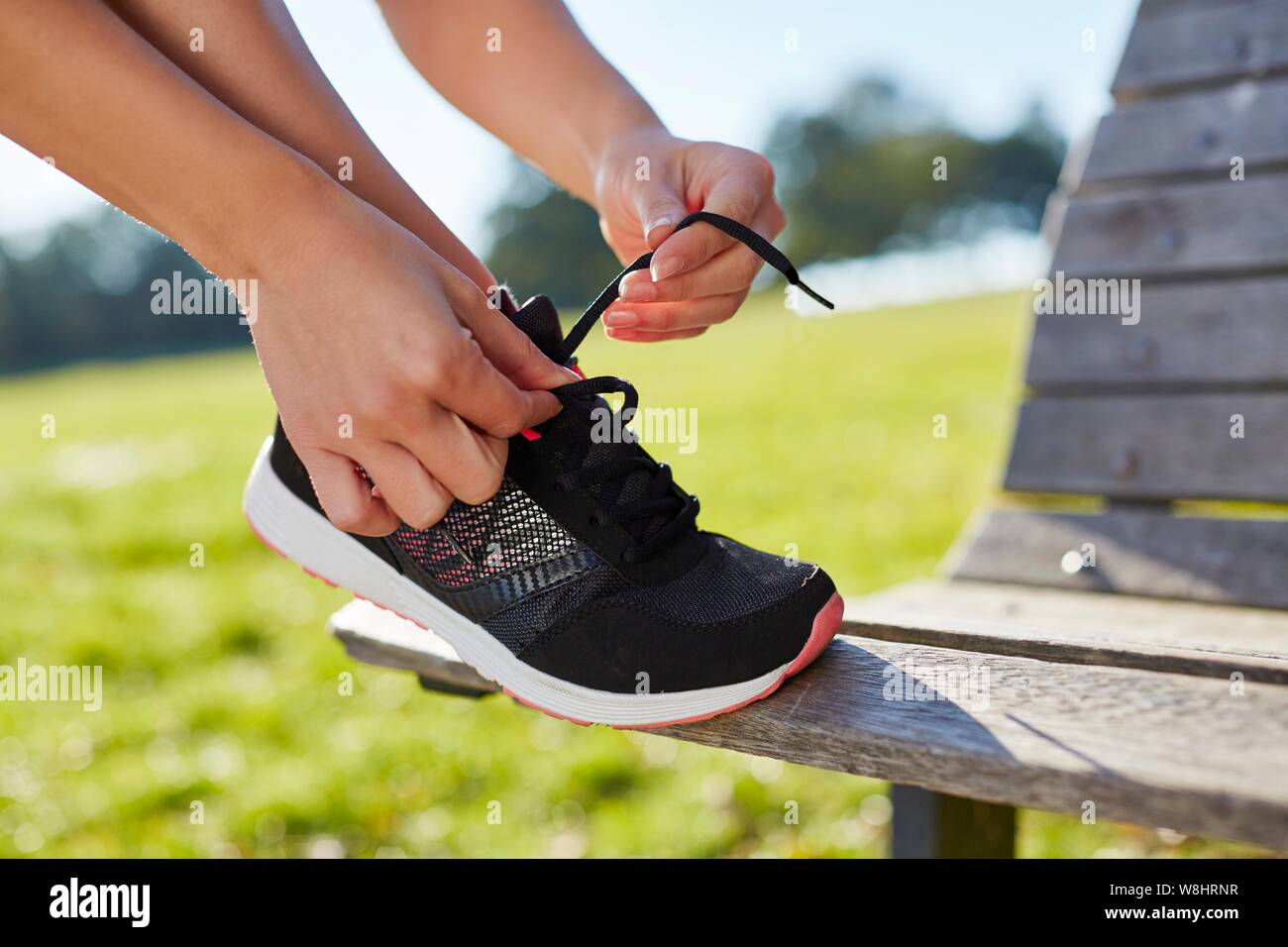 Woman tying up trainers. Stock Photo