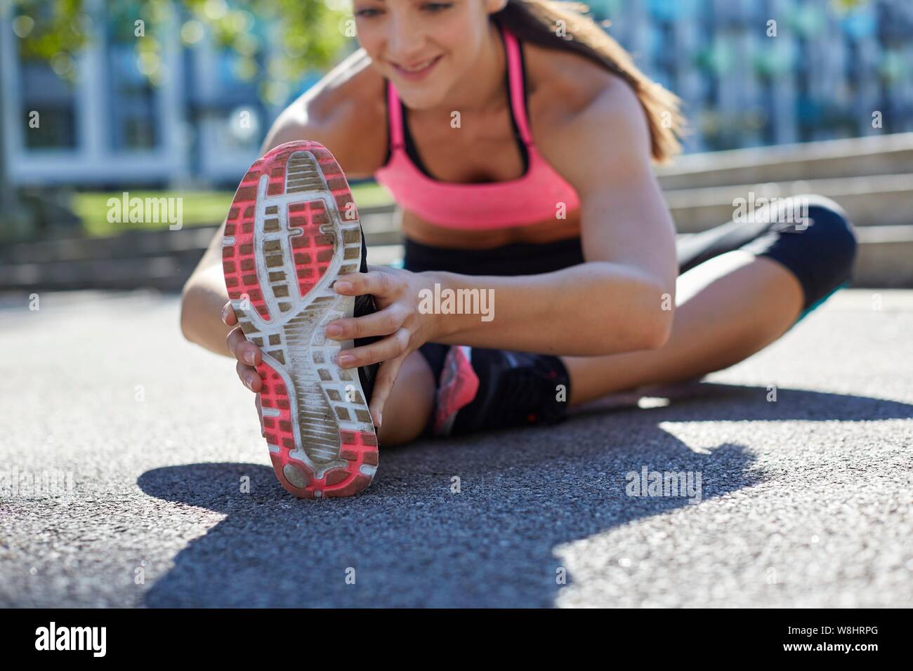 Young woman stretching her leg. Stock Photo