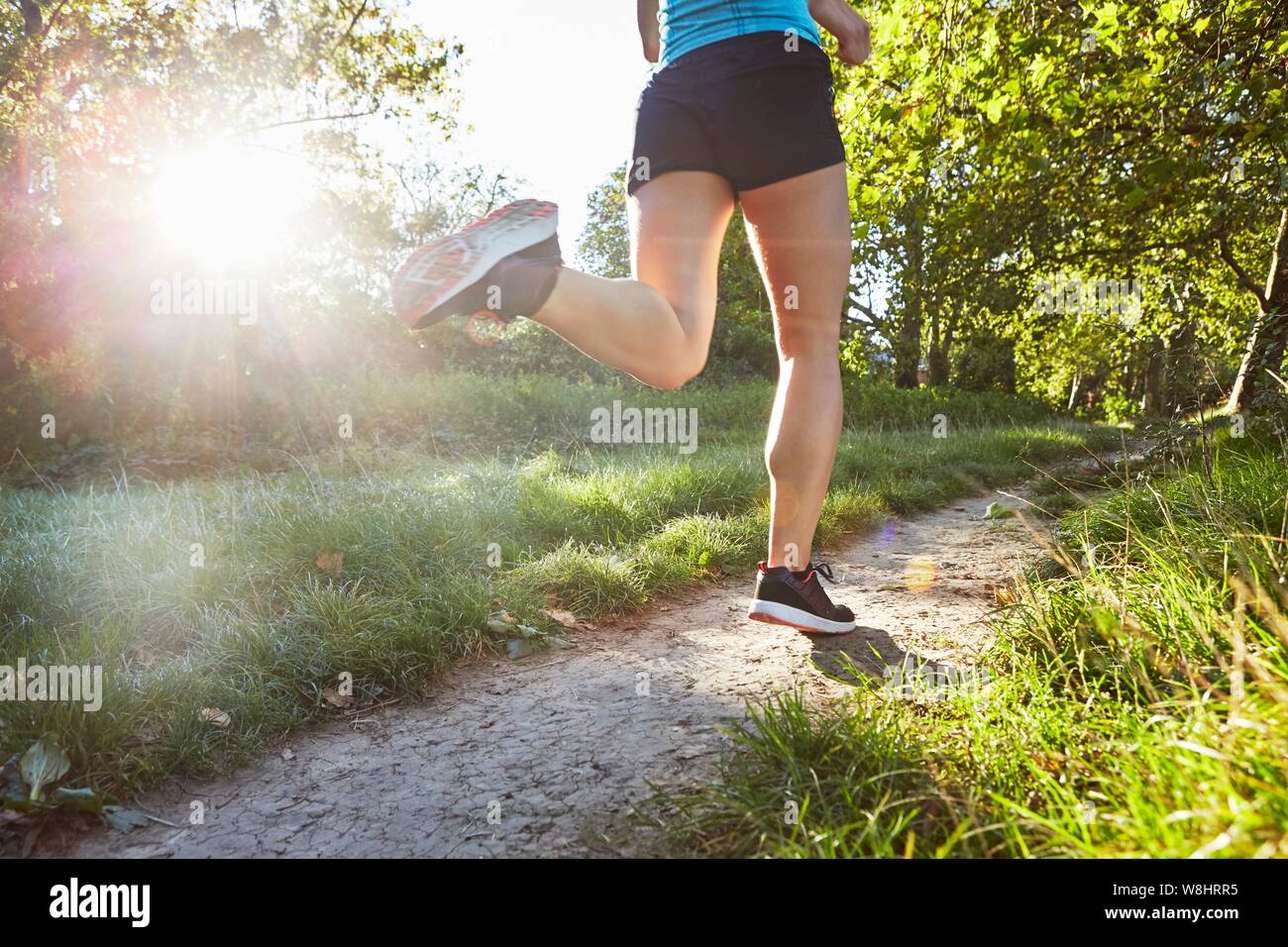 Young woman jogging on path. Stock Photo