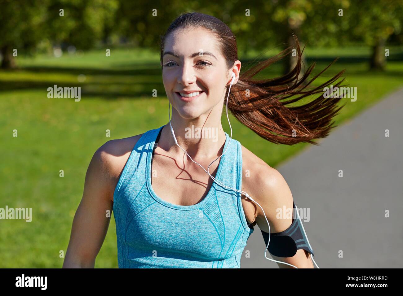 Young woman jogging on a path. Stock Photo