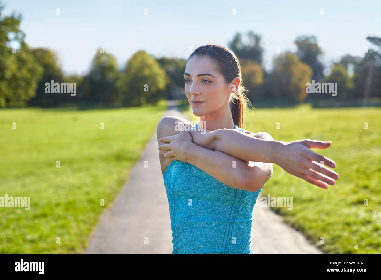 Young woman stretching arm. Stock Photo
