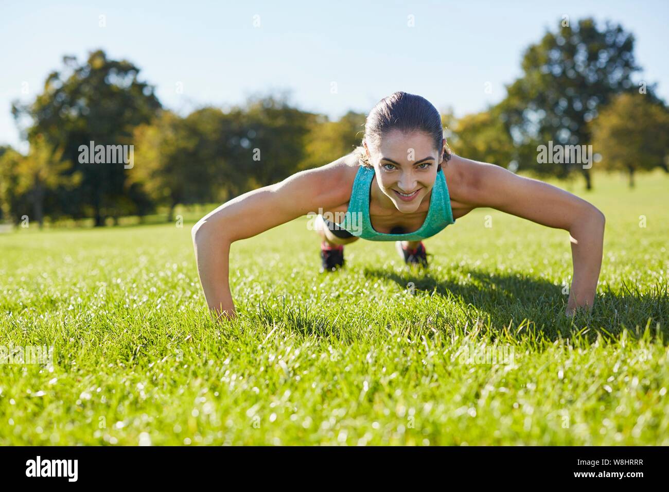 Young woman doing push-up. Stock Photo