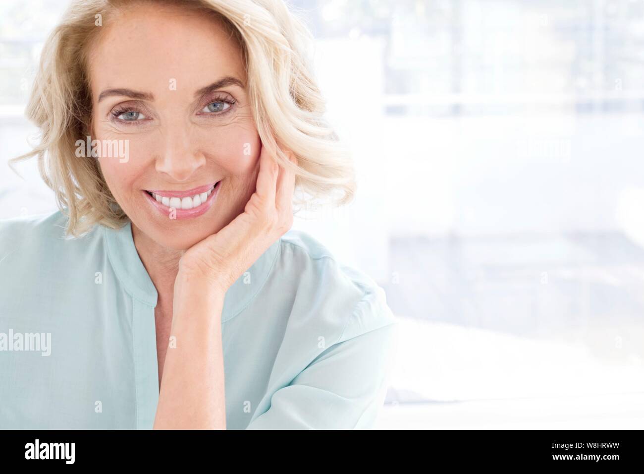 Mature woman smiling towards camera. Stock Photo