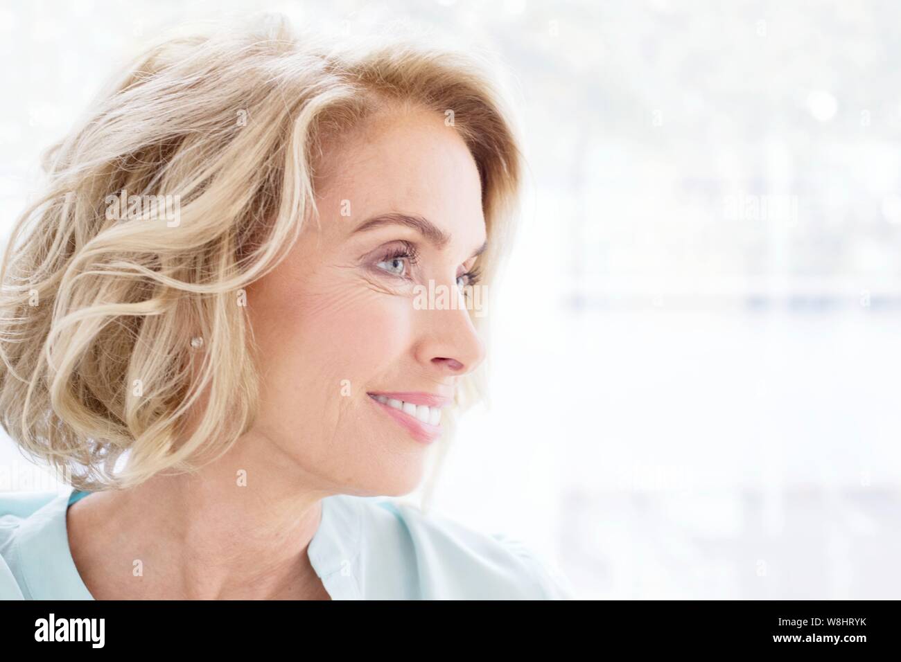 Mature woman smiling and looking away. Stock Photo