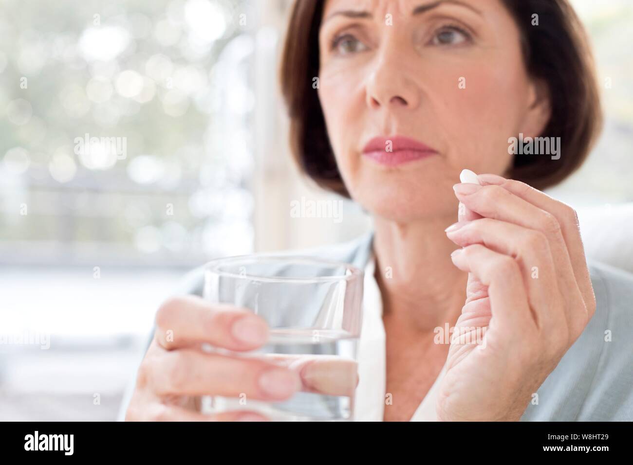 Mature woman taking tablet. Stock Photo