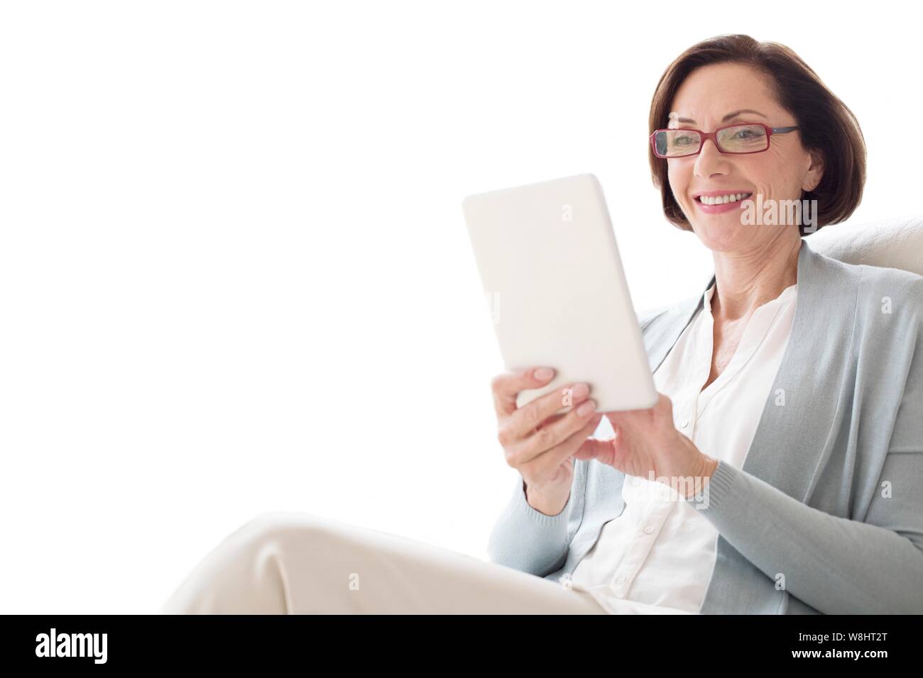 Mature woman using digital tablet. Stock Photo