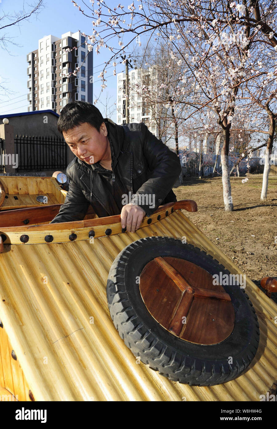 Chinese carpenter Liu Fulong checks the seat of his third homemade