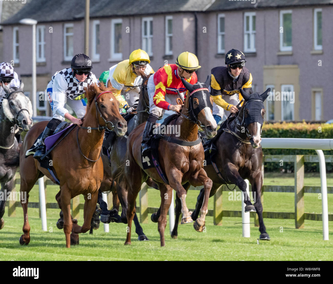 Musselburgh Races - 9th August 2019 - Jockey Harrison Shaw (plain black hat) on Economic Crisis, winner of the 'Boogie In The Morning Handicap' Stock Photo