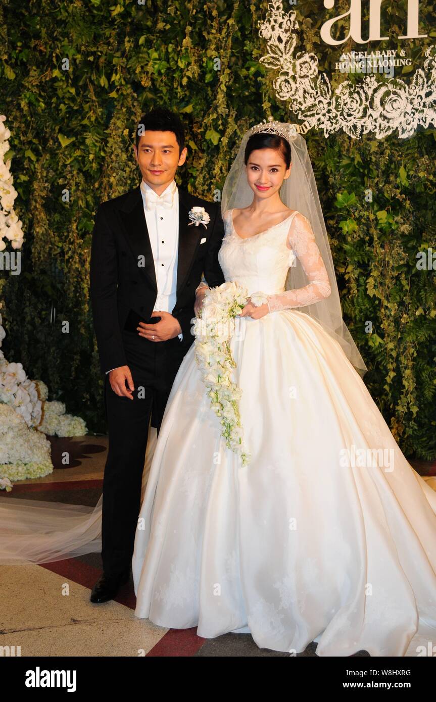 Chinese actor Huang Xiaoming, left, and his actress wife Angelababy pose  during their wedding ceremony at the Shanghai Exhibition Center in Shanghai  Stock Photo - Alamy