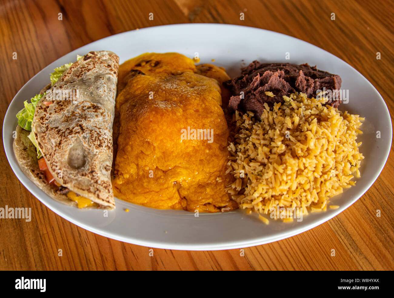 Cheese Enchiladas with rice, beans and beef taco Stock Photo Alamy
