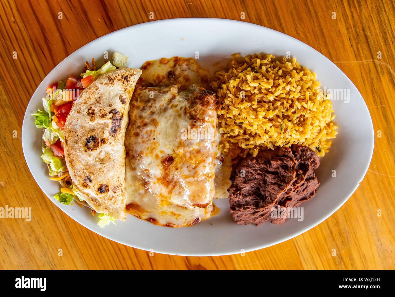 Chicken Enchilada plate with rice, beans and chicken taco Stock Photo