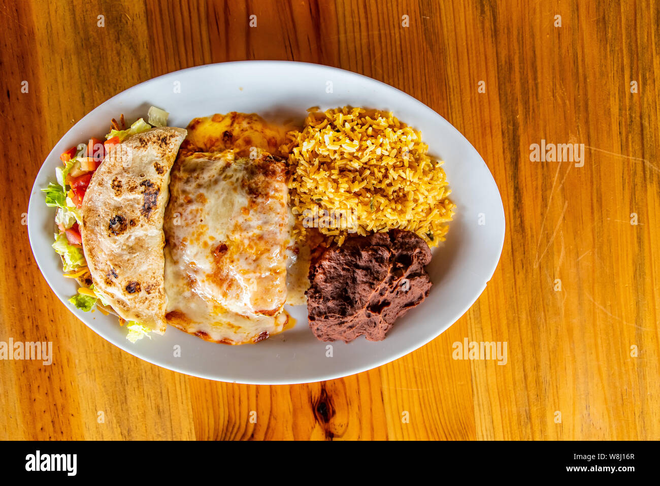 Chicken Enchilada plate with rice, beans and chicken taco Stock Photo