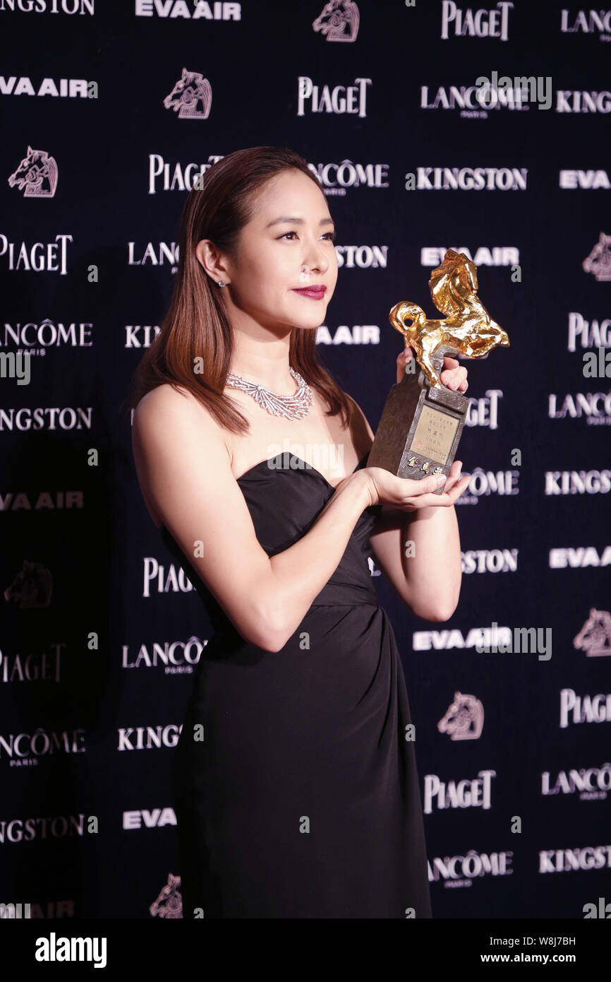 Taiwanese actress Karena Lam poses with her trophy for Best Leading ...