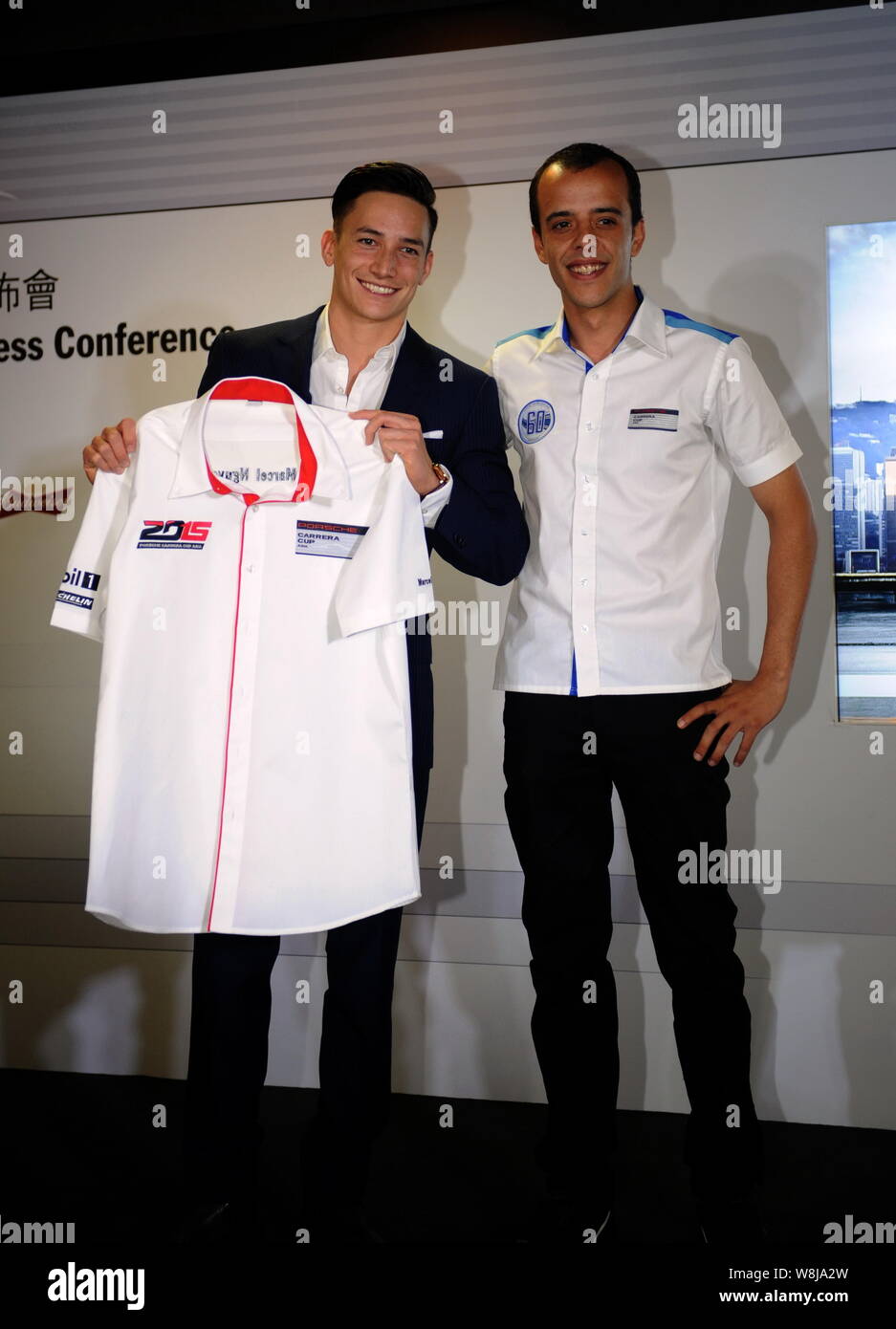 German gymnast Marcel Nguyen, left, poses during a press conference for the 2015 Porsche Carrera Cup Asia season in Hong Kong, China, 1 April 2015. Stock Photo