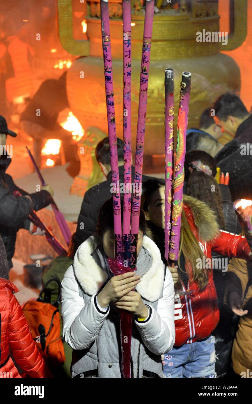 Chinese worshippers burn incense sticks to pray for good fortune and