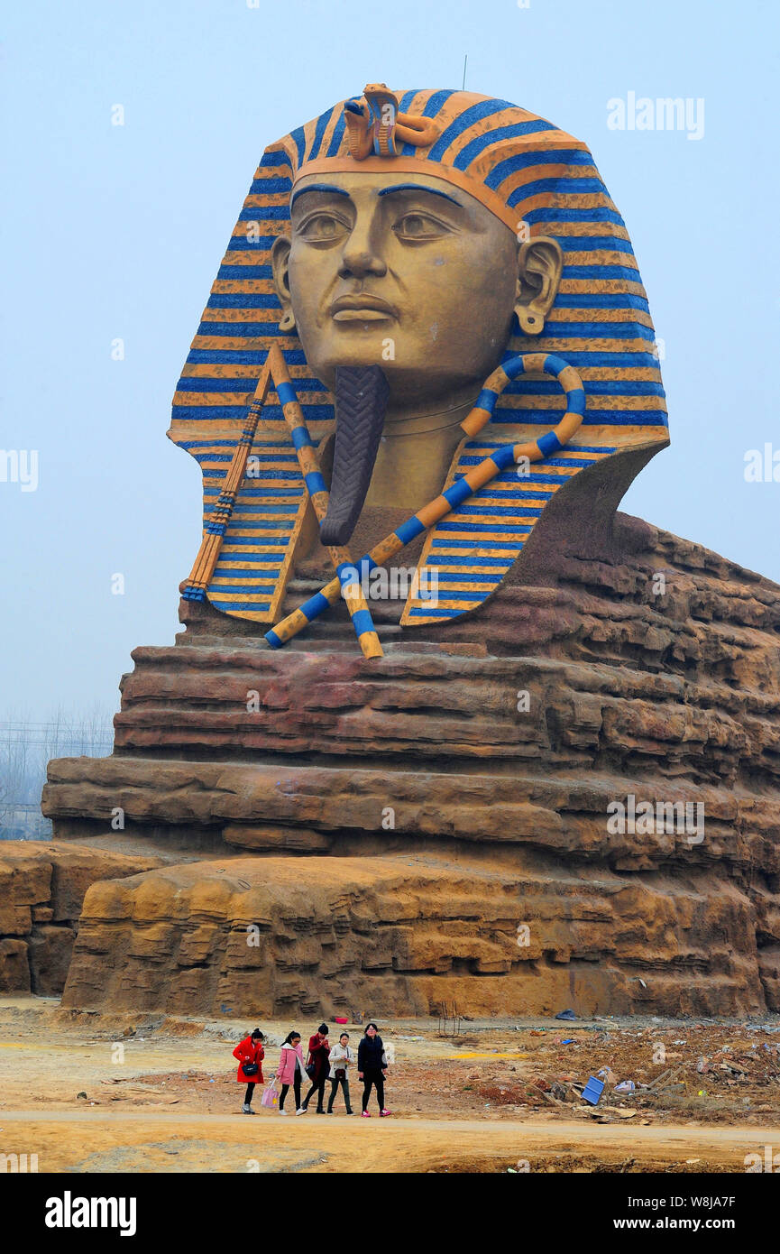 Visitors walk past the replica of the Great Sphinx at the