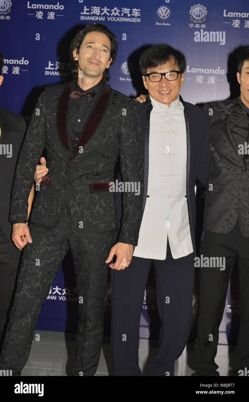 American actor Adrien Brody, left, Hong Kong kungfu star Jackie Chan, center, and other guests pose on the red carpet for the 16th Huading Awards cere Stock Photo