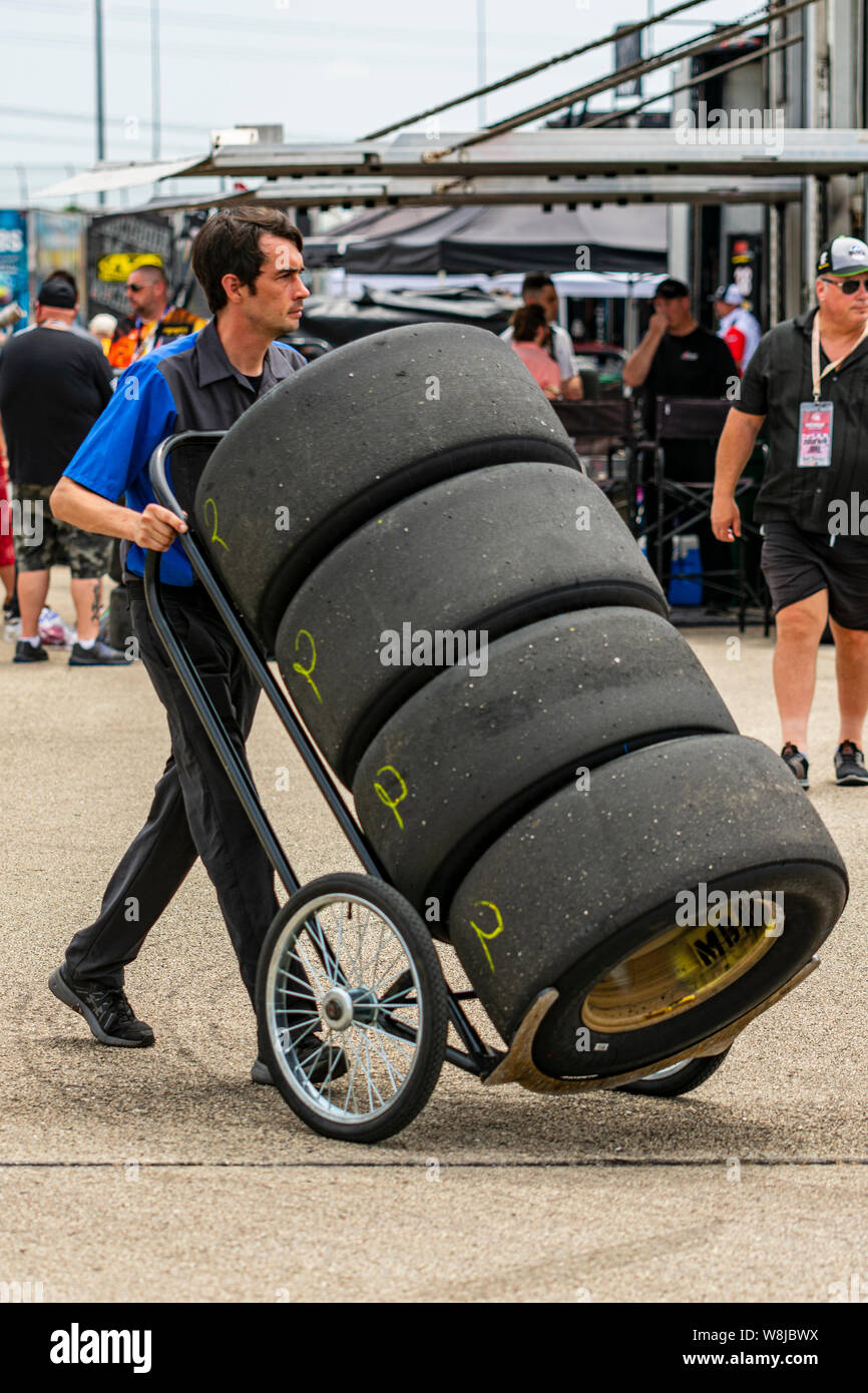 Joliet, IL, United States June 29, 2019 Man transporting tires before the Camping World 300
