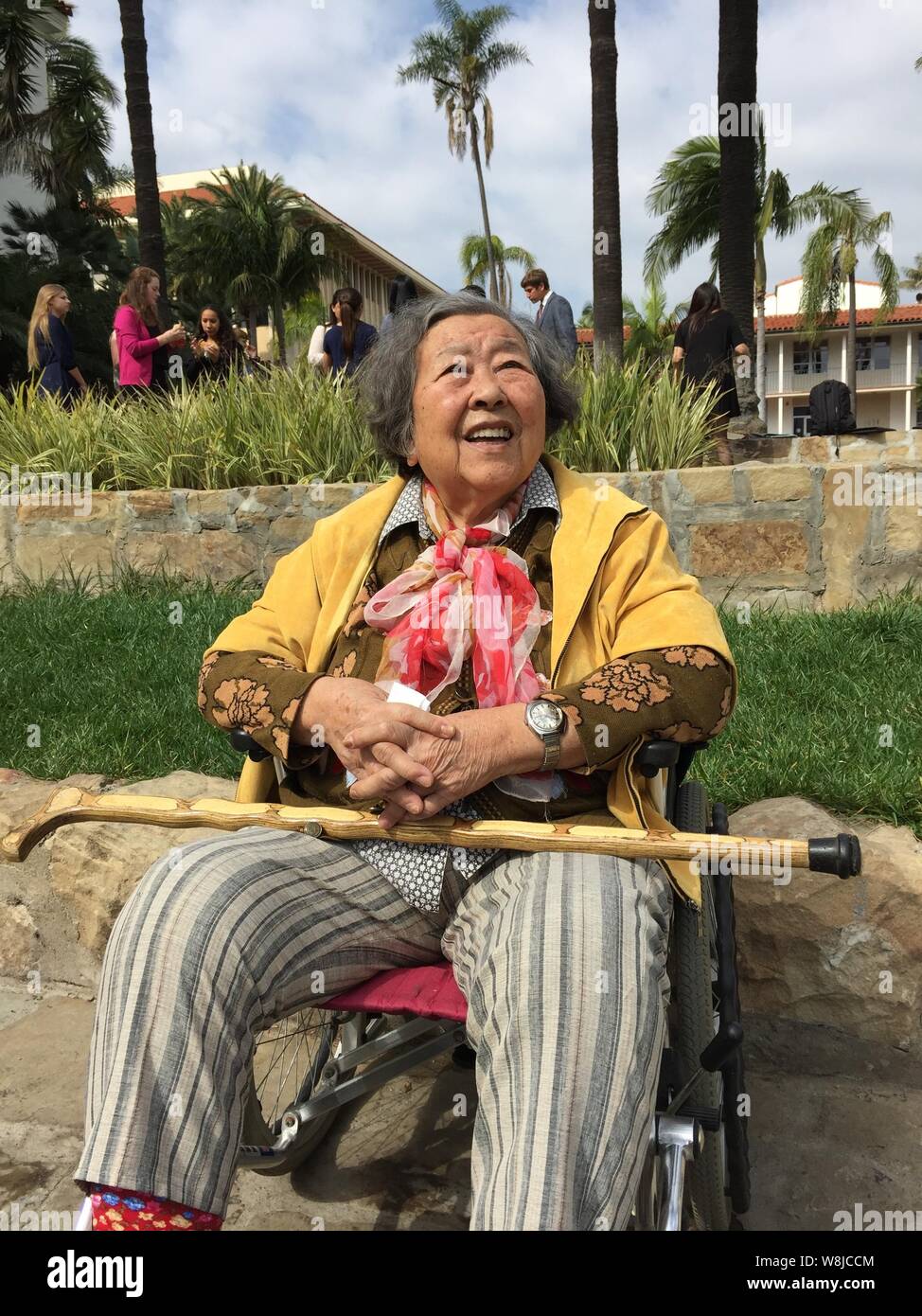 The mother of An Rong smiles as she poses on her wheelchair in a small ...