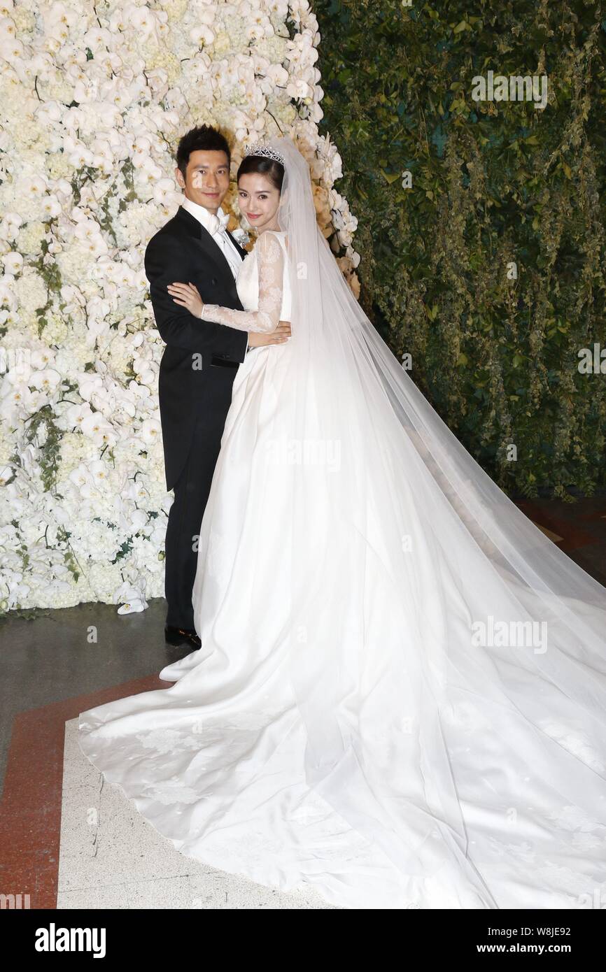 Chinese Actor Huang Xiaoming Left And His Actress Wife Angelababy Pose During Their Wedding Ceremony At The Shanghai Exhibition Center In Shanghai Stock Photo Alamy