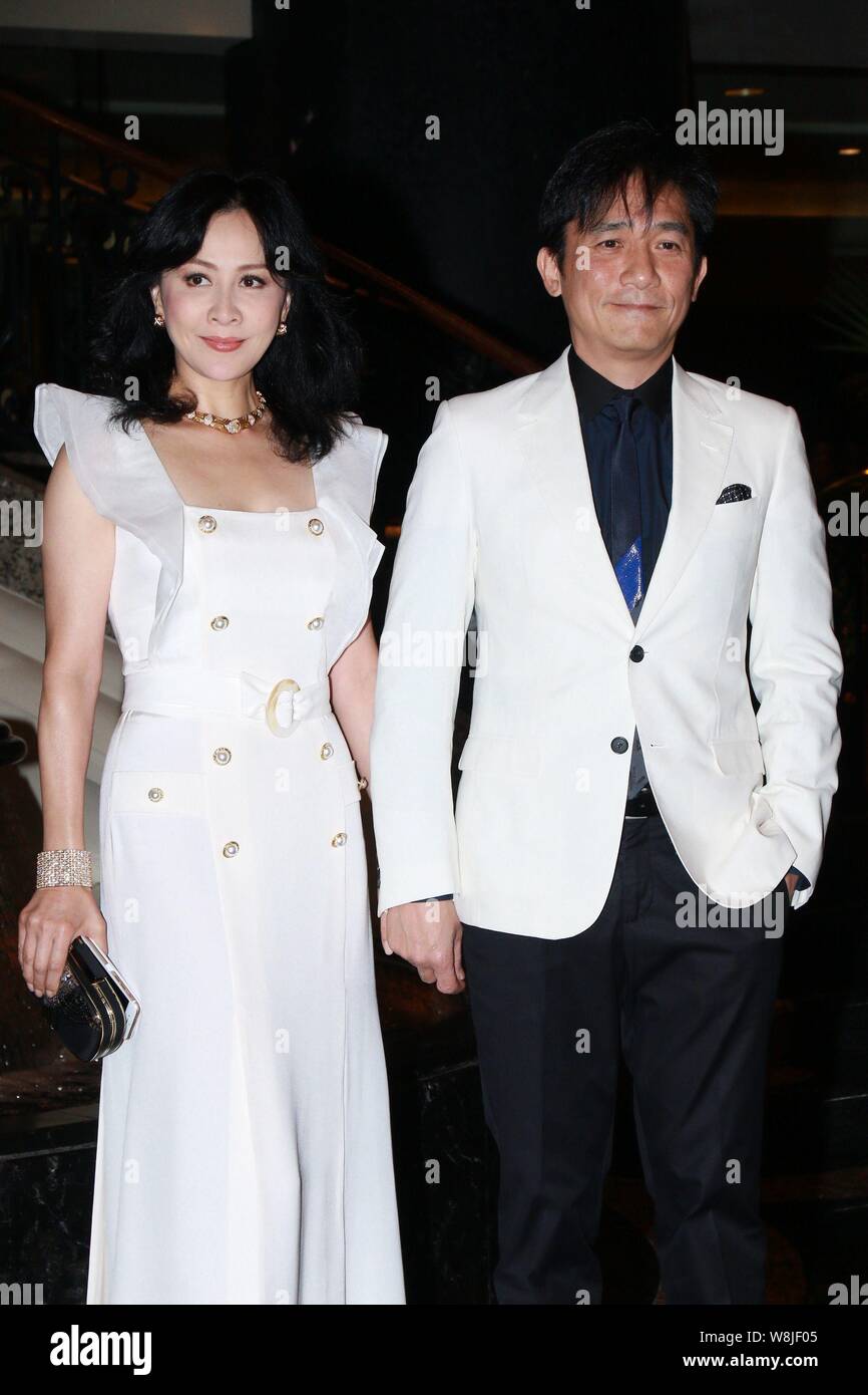 Hong Kong actress Carina Lau, left, and her actor husband Tony leung chiu wai, pose as they arrive for the wedding party of Hong Kong actor Kenny Bee Stock Photo