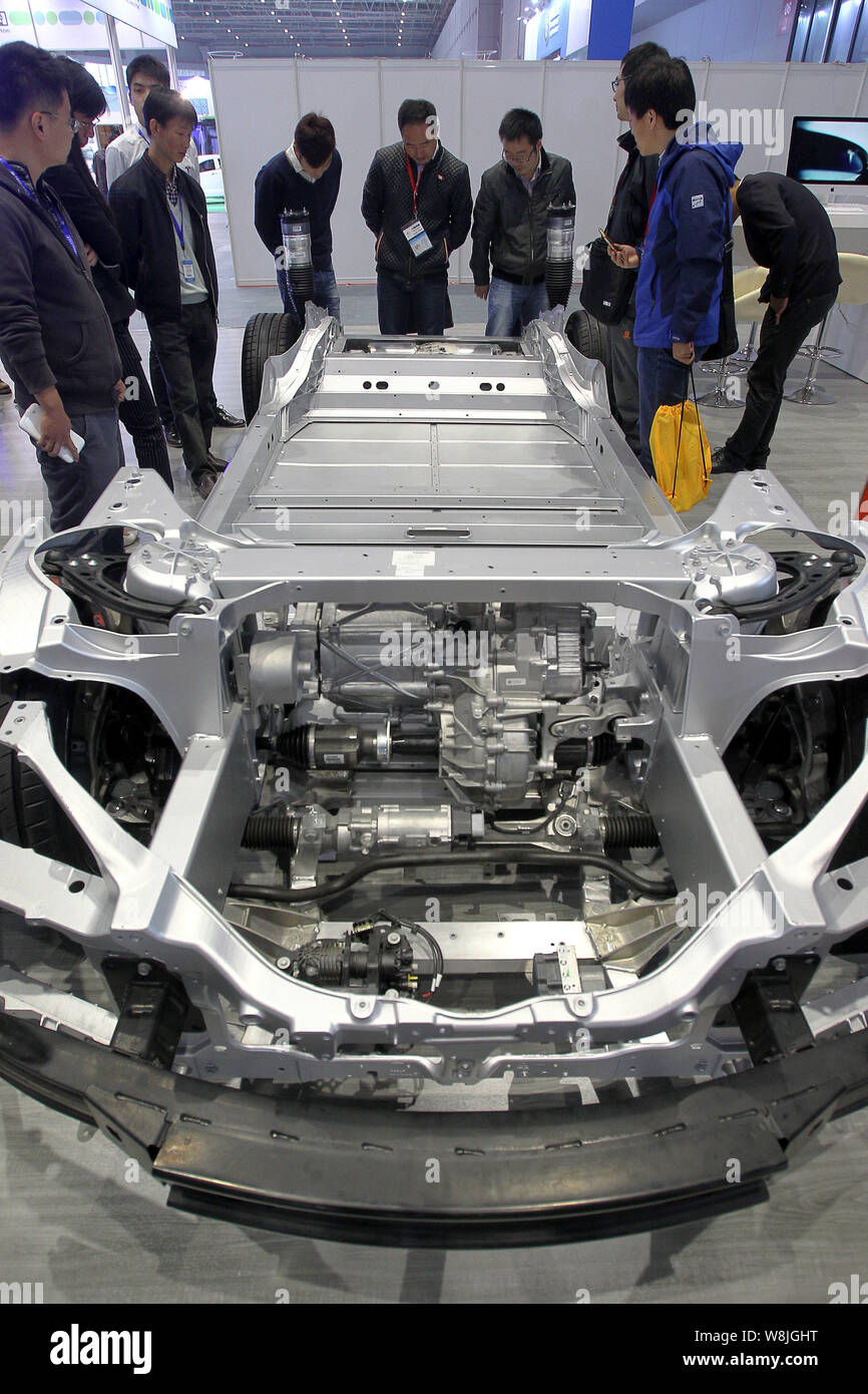 Visitors look at the chassis of a Tesla Model S electric car during the 17th China International Industry Fair in Shanghai, China, 3 November 2015. Stock Photo