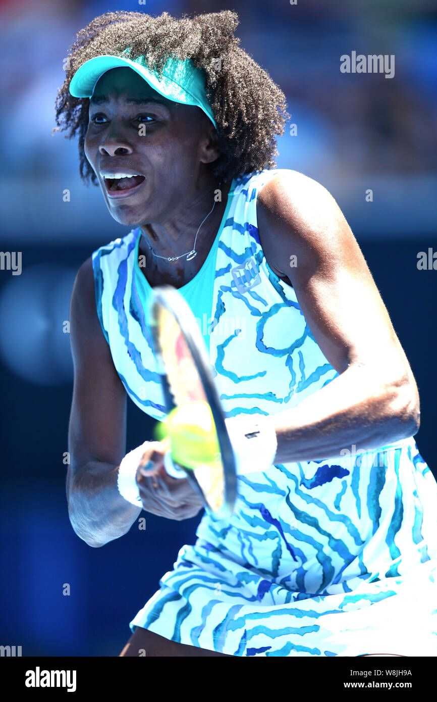 Venus Williams of the U.S. returns a shot to Camila Giorgi of Italy during their third round match at the Australian Open tennis tournament in Melbour Stock Photo