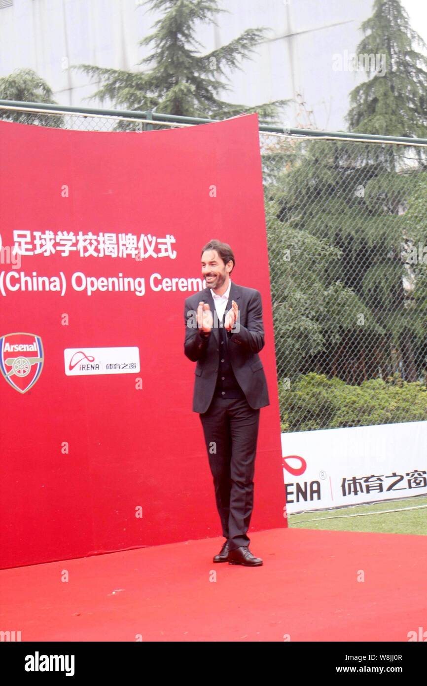 Retired French football player Robert Pires applauds during the opening ceremony of the Arsenal Soccer School (China) in Shanghai, China, 29 November Stock Photo