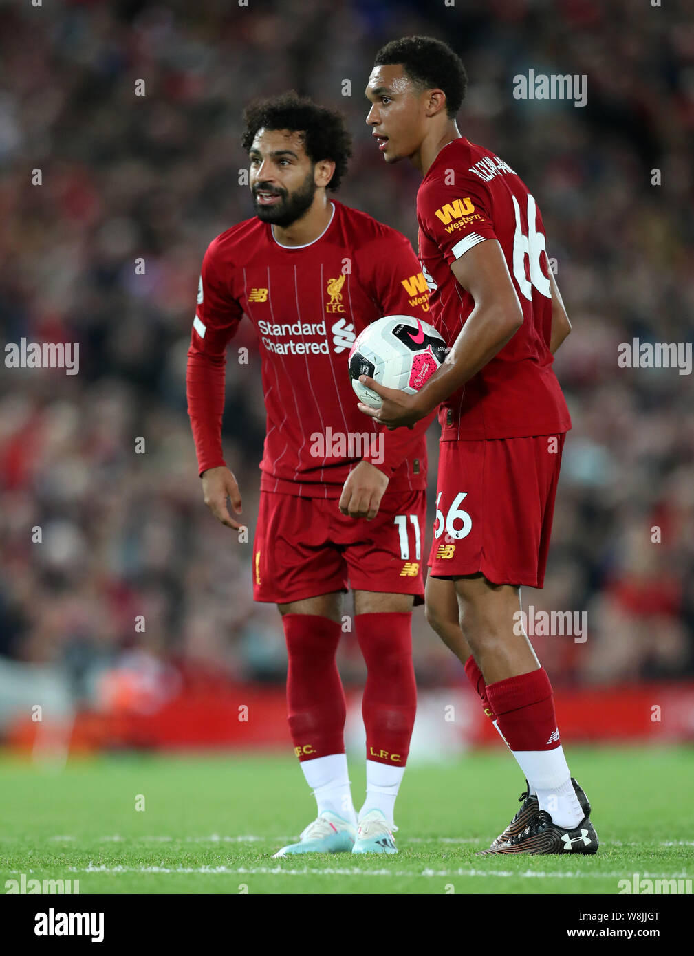 Anfield, Liverpool, UK. 9th Aug, 2019. Premier League Football, Liverpool  versus Norwich; Mohammed Salah of Liverpool and Trent Alexander-Arnold of  Liverpool line up a direct free kick on goal - Strictly Editorial