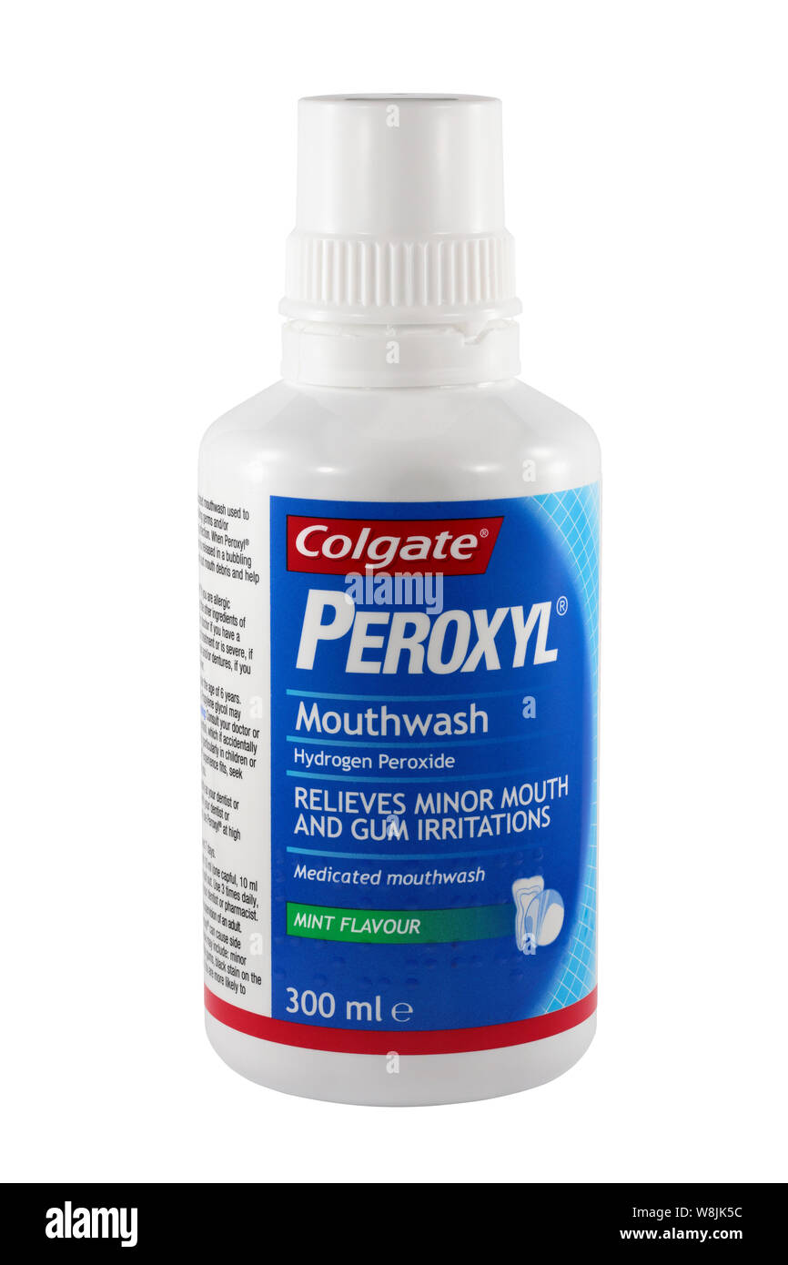 A 300ml bottle of Colgate Mint Flavour Peroxyl mouthwash isolated on a white background.  Hydrogen Peroxide.  Relieves minor mouth and gum irritations Stock Photo