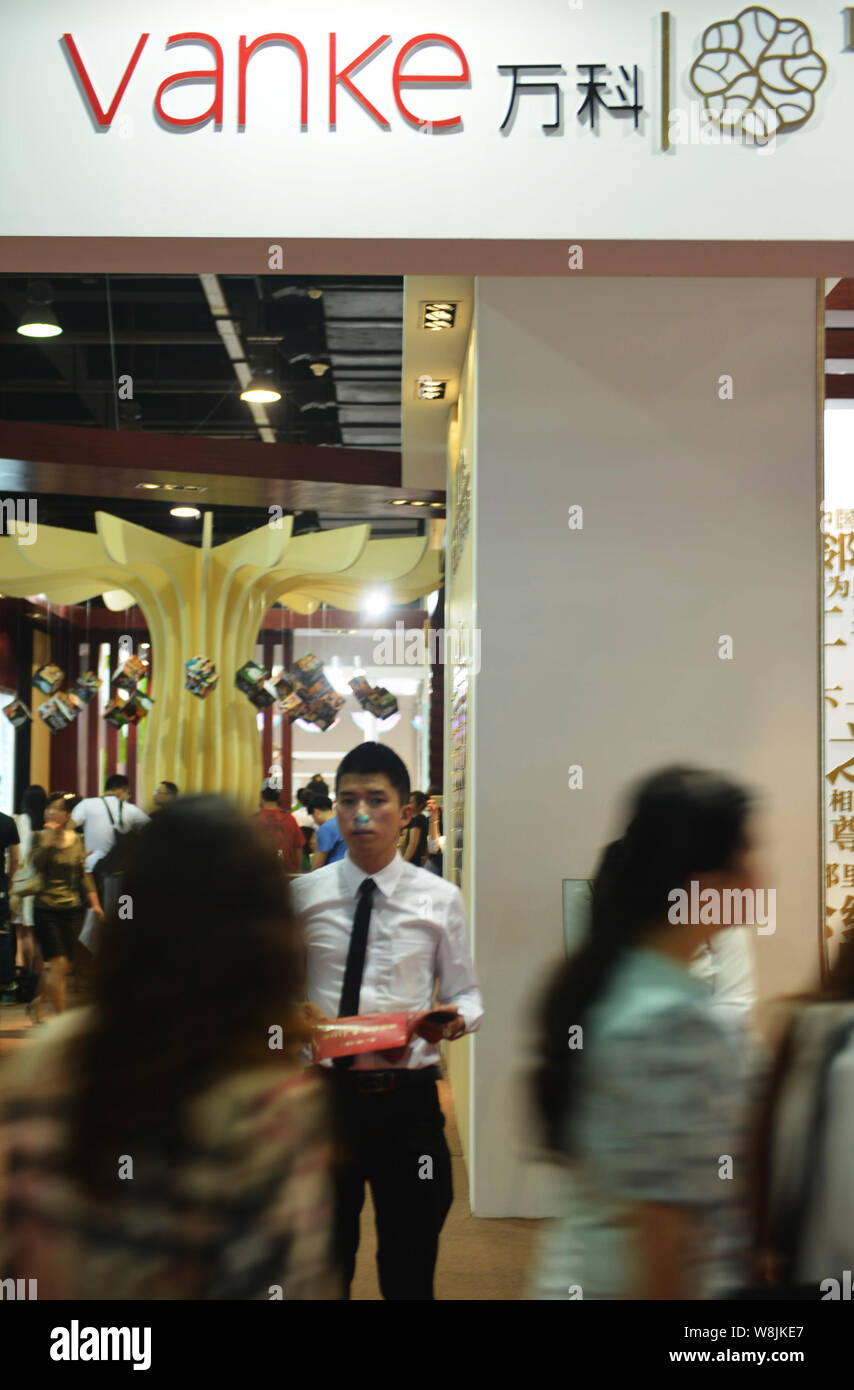 FILEPeople visit the stand of Vanke during a real estate fair in