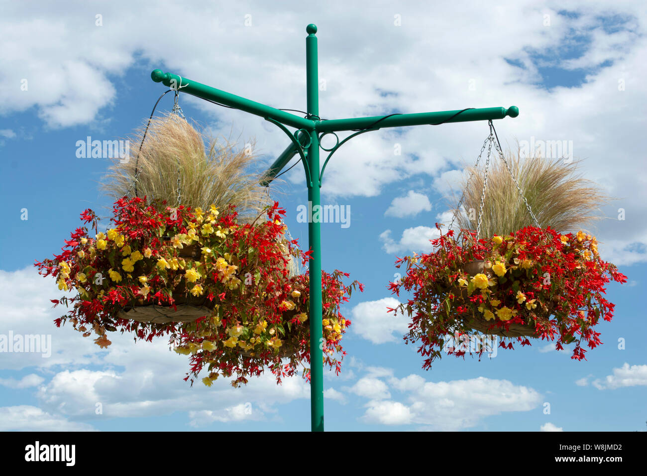 Hanging planters for flowers and natural grass in public location Stock Photo
