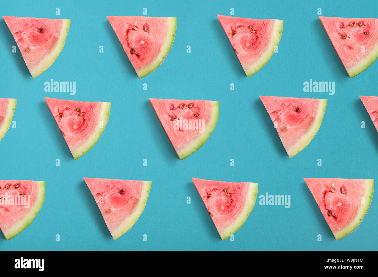 Colorful fruit pattern of watermelon slices on blue background, top ...