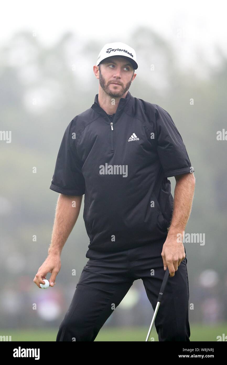 American golfer Dustin Johnson reacts after making a putt during the