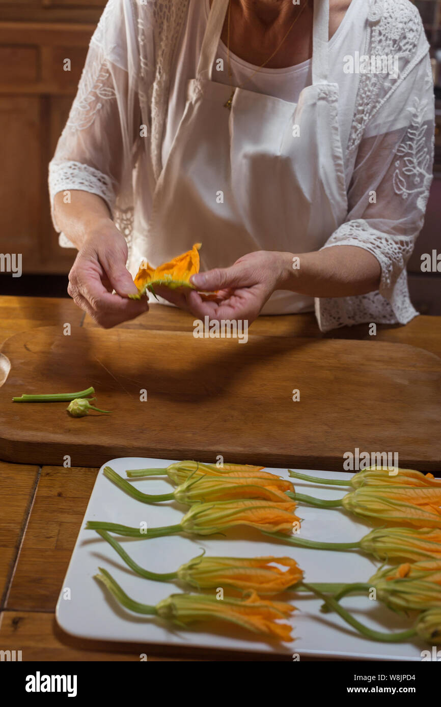 step by step process of cooking courgette flower Provence dish hands